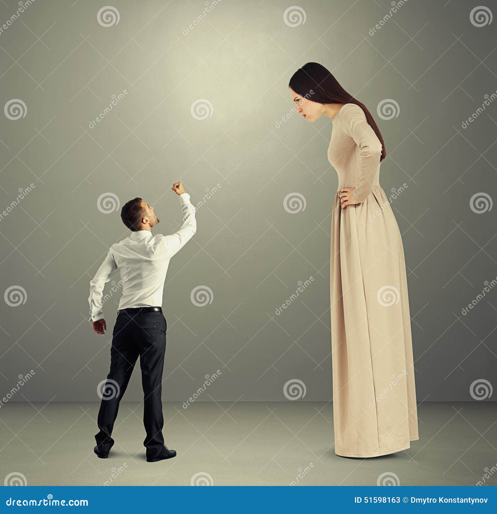 Man Showing Fist To Dissatisfied Woman Stoc
