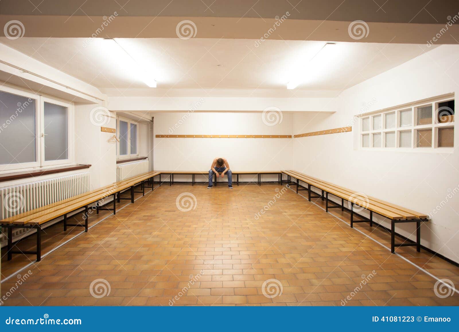 man-sitting-empty-locker-room-old-410812