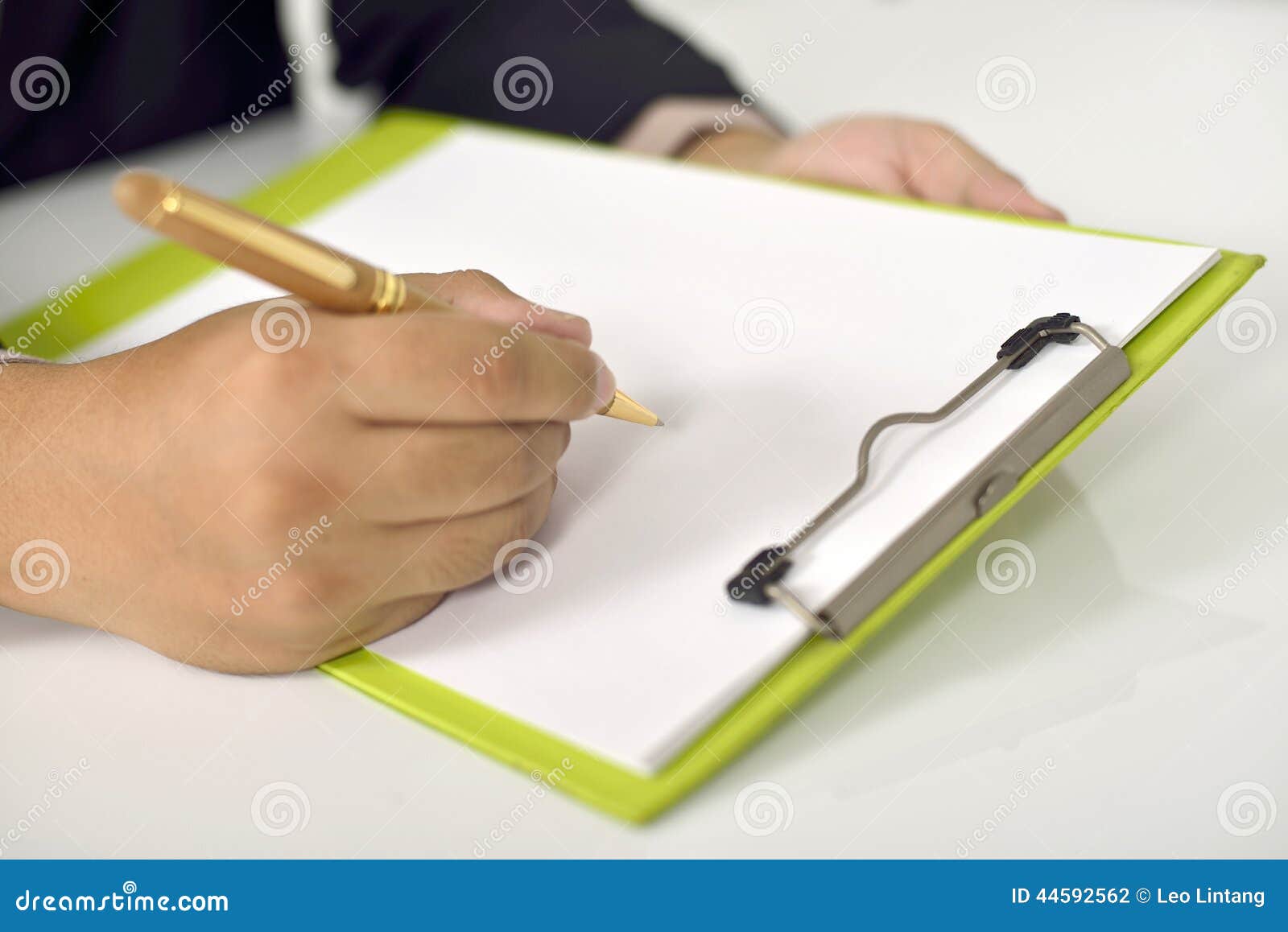 Man writing on blank paper. You can put your design.