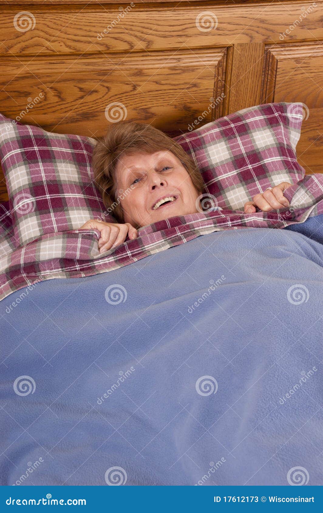  - mature-senior-woman-smiling-happy-bed-17612173