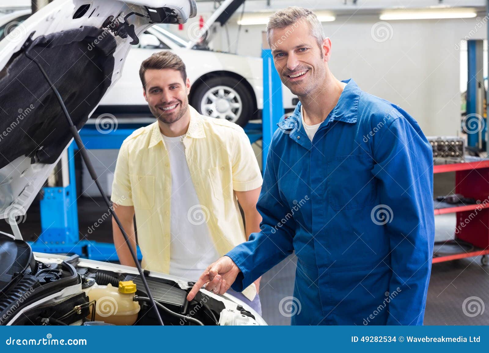 Mechanic Showing Customer The Problem With Car Stock Photo  Image 