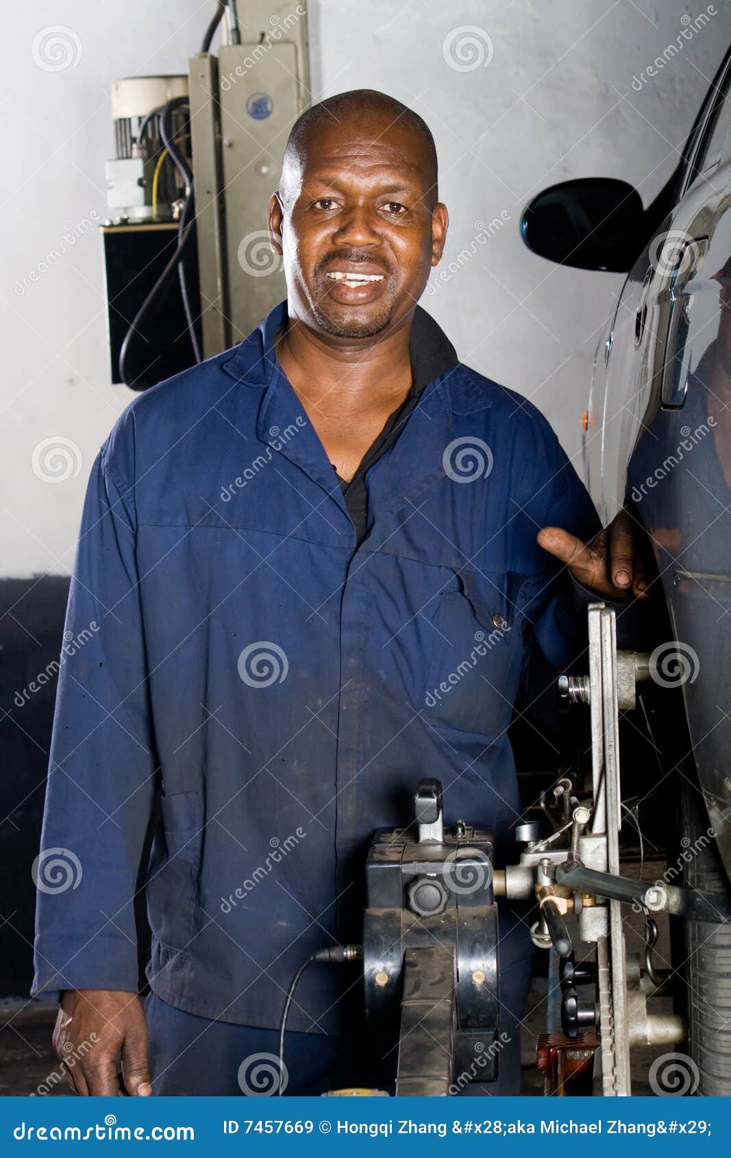 African mechanic working on vehicle .