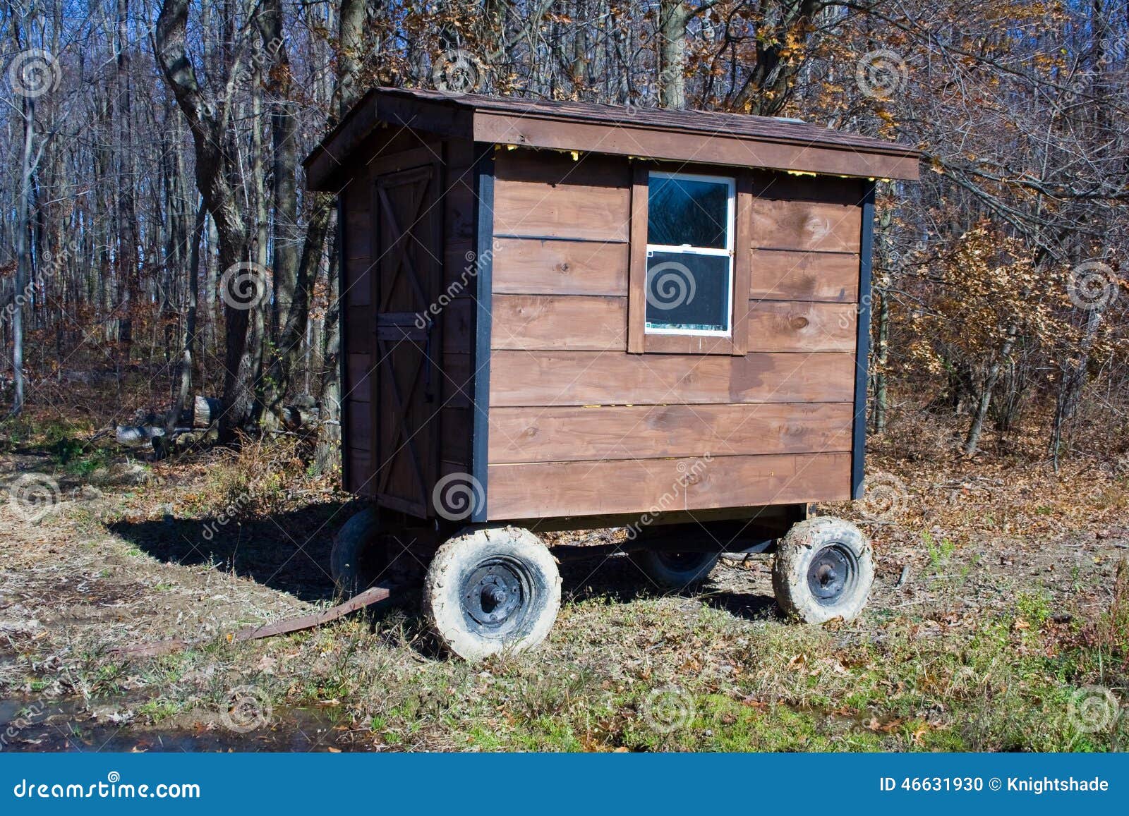 Small shed built on chassis with wheels for mobility.