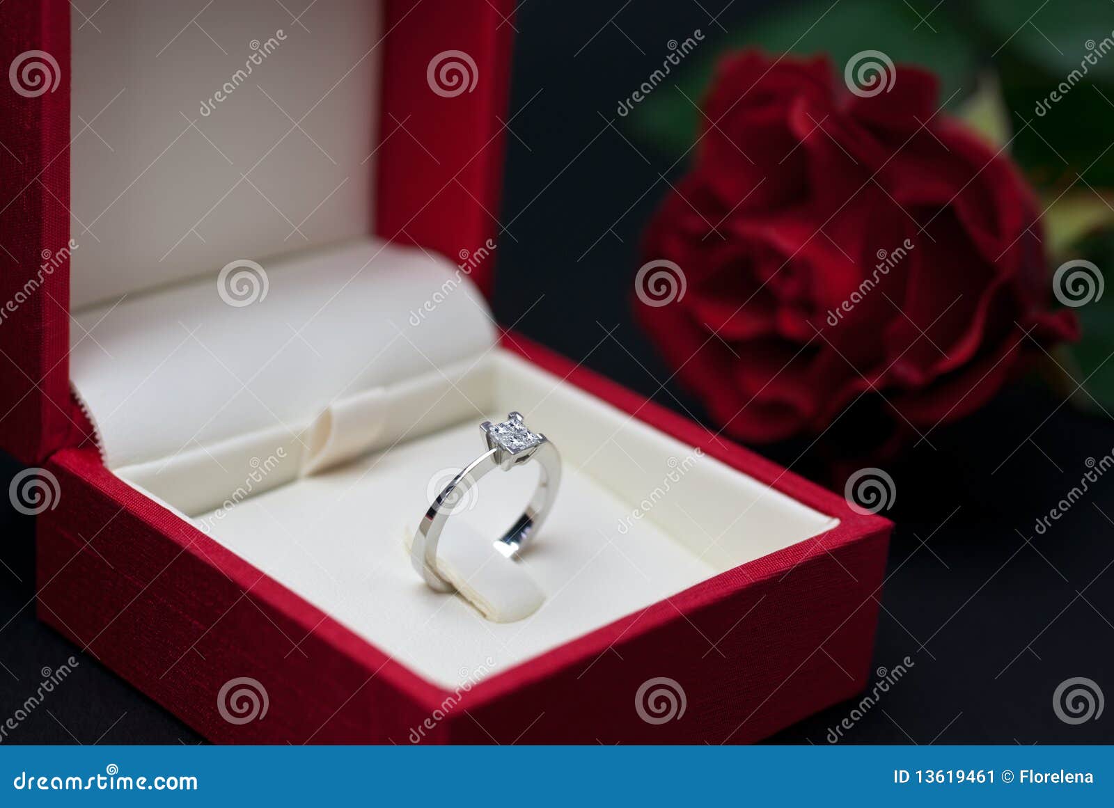  engagement ring in red jewellery box on black background (soft focus