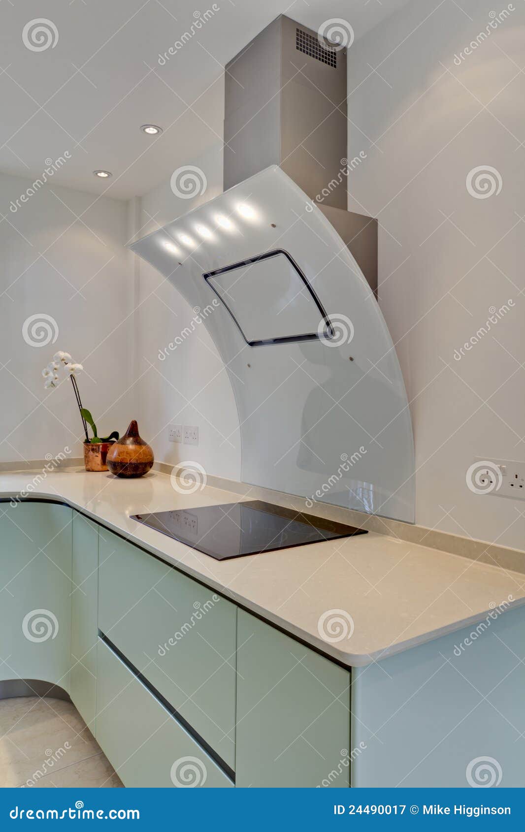 Modern contemporary cooker hood and hob within fitted kitchen with ...