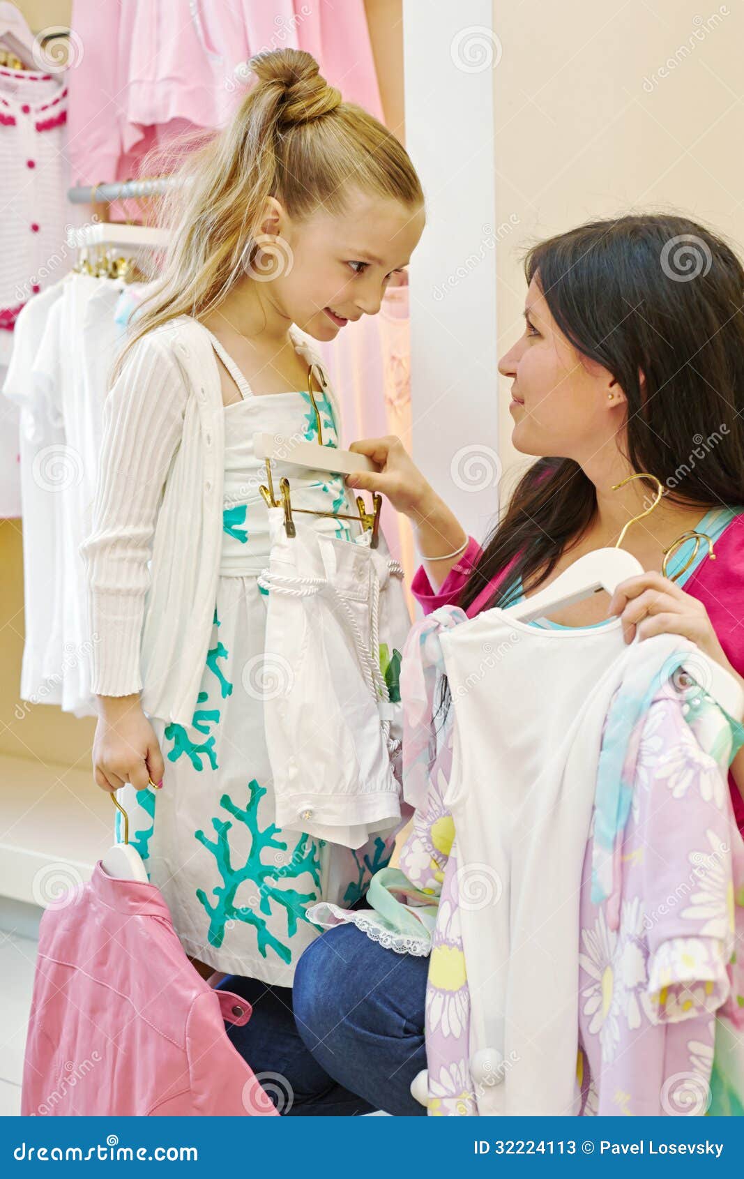 Portrait Of A Mother And Daughter Shopping For Clothes Stock Photo