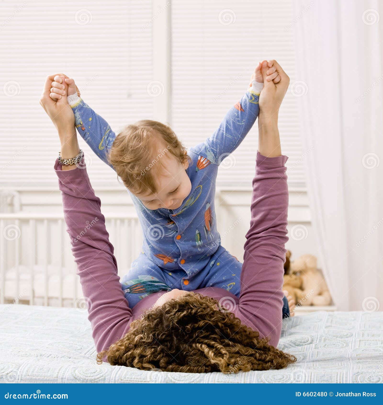 Mother Playing With Son On Bed In Bedroom Stock Photo - Image: 6602480