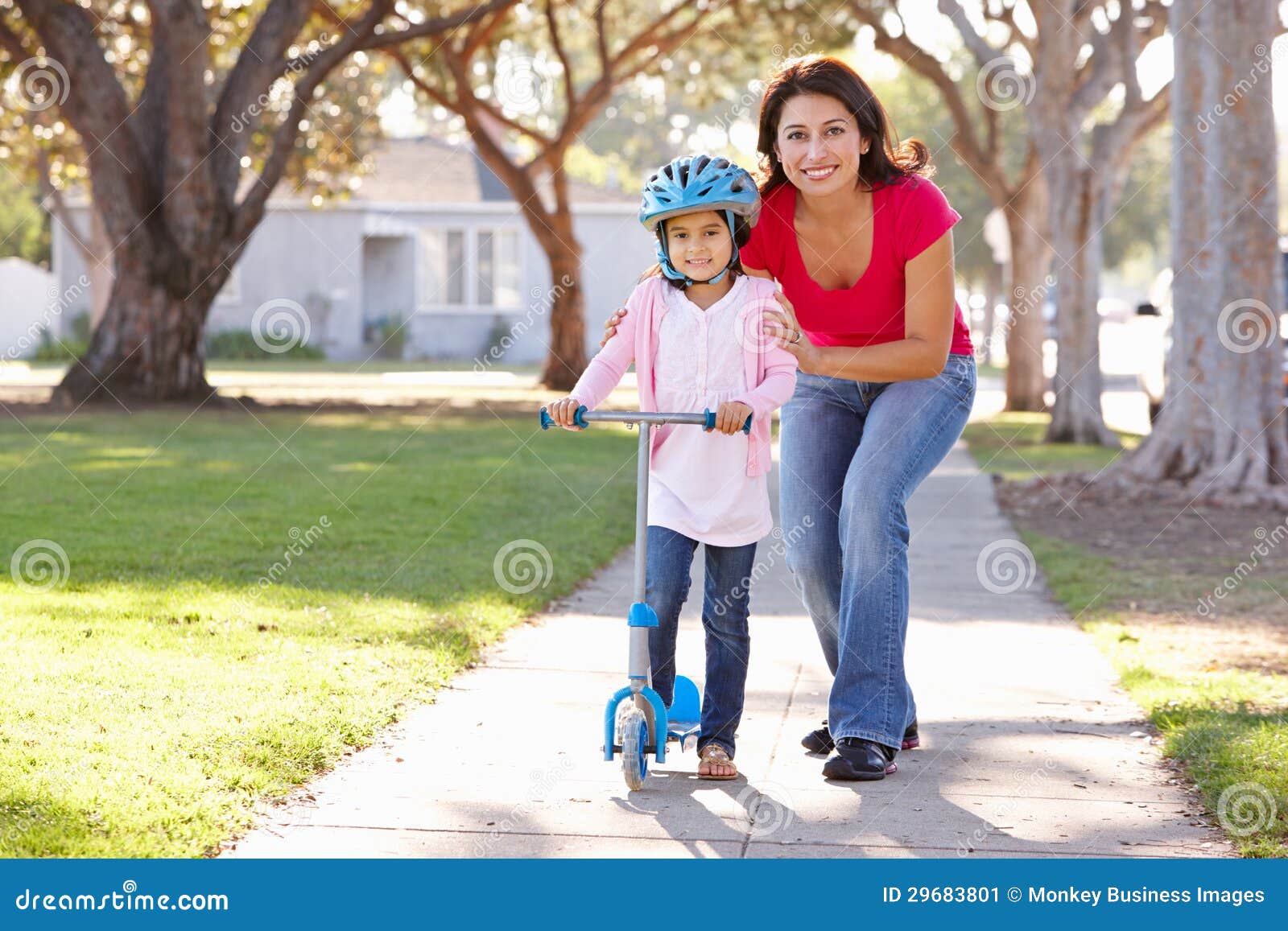 Mother Teaching Daughter To Ride Scooter Stock Image Image 29683801