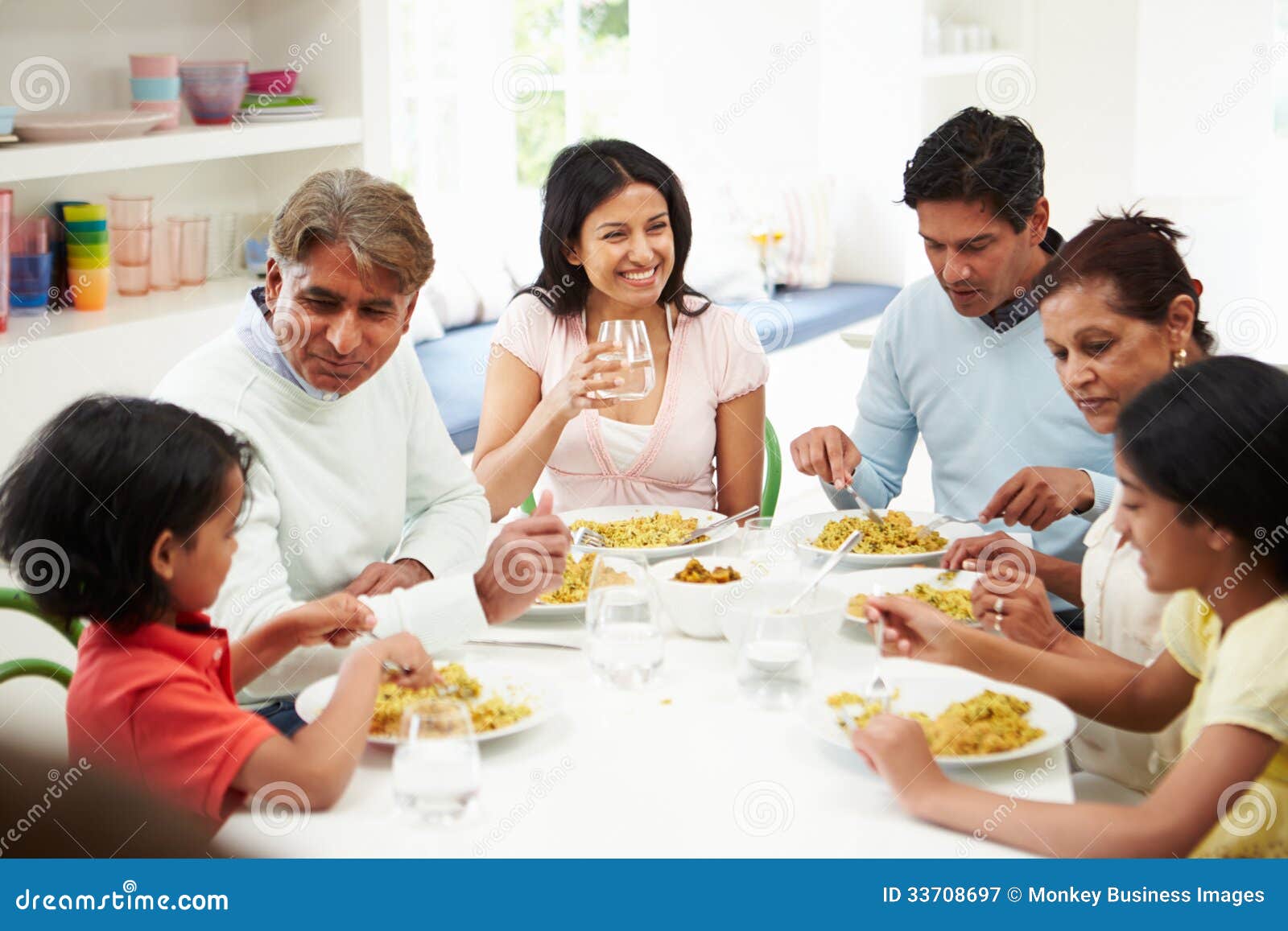 Multi Generation Indian Family Eating Meal At Home Royalty Free Stock 