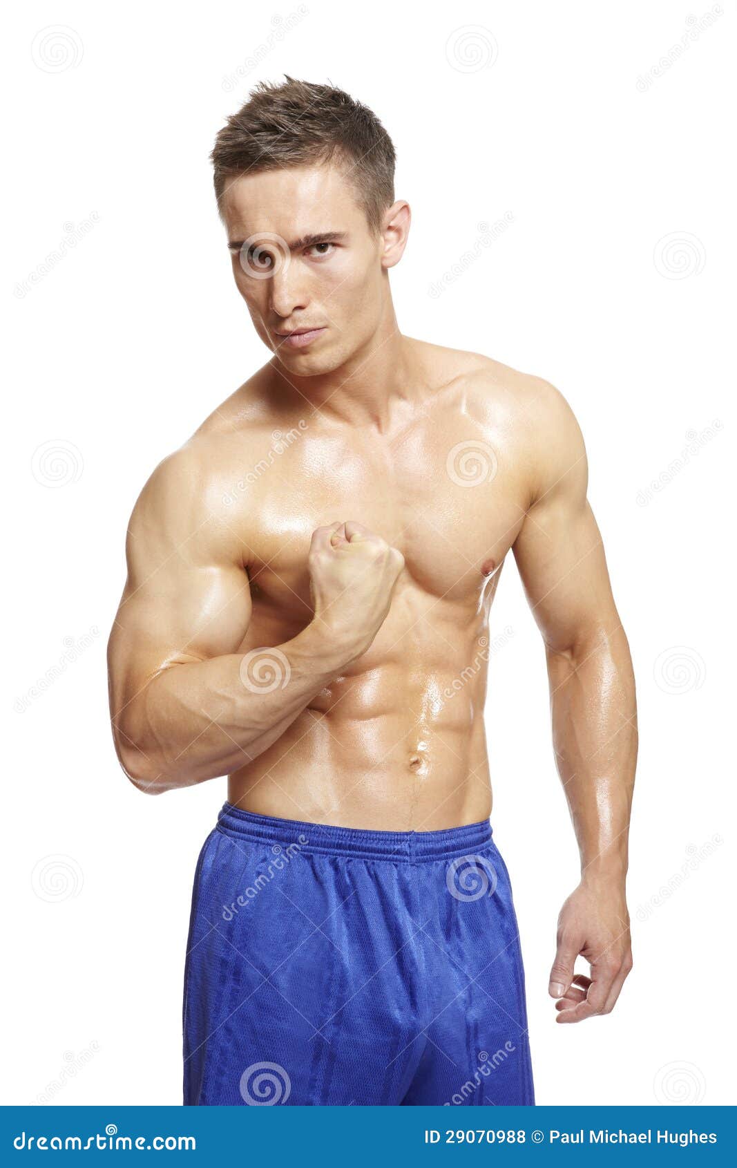 Stock Photos: Muscular young man flexing arm muscles in sports outfit Stock Photos: Muscular young man flexing arm muscles in sports outfit