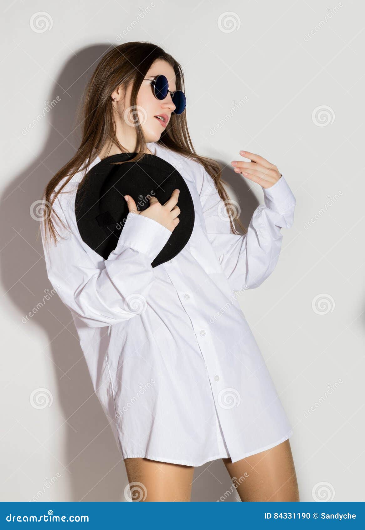 Naked Girl In A Man S White Shirt Sunglasses And Black Hat Stock Photo