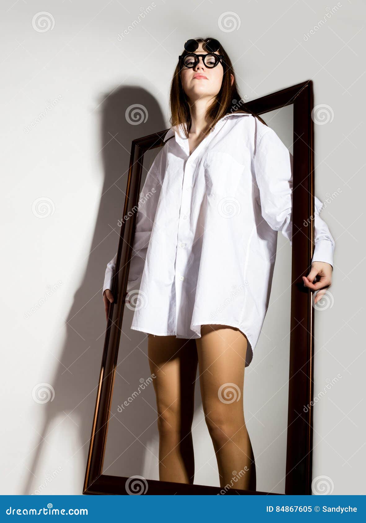 Naked Girl In A Man S White Shirt And Sunglasses Holding Wooden Frame
