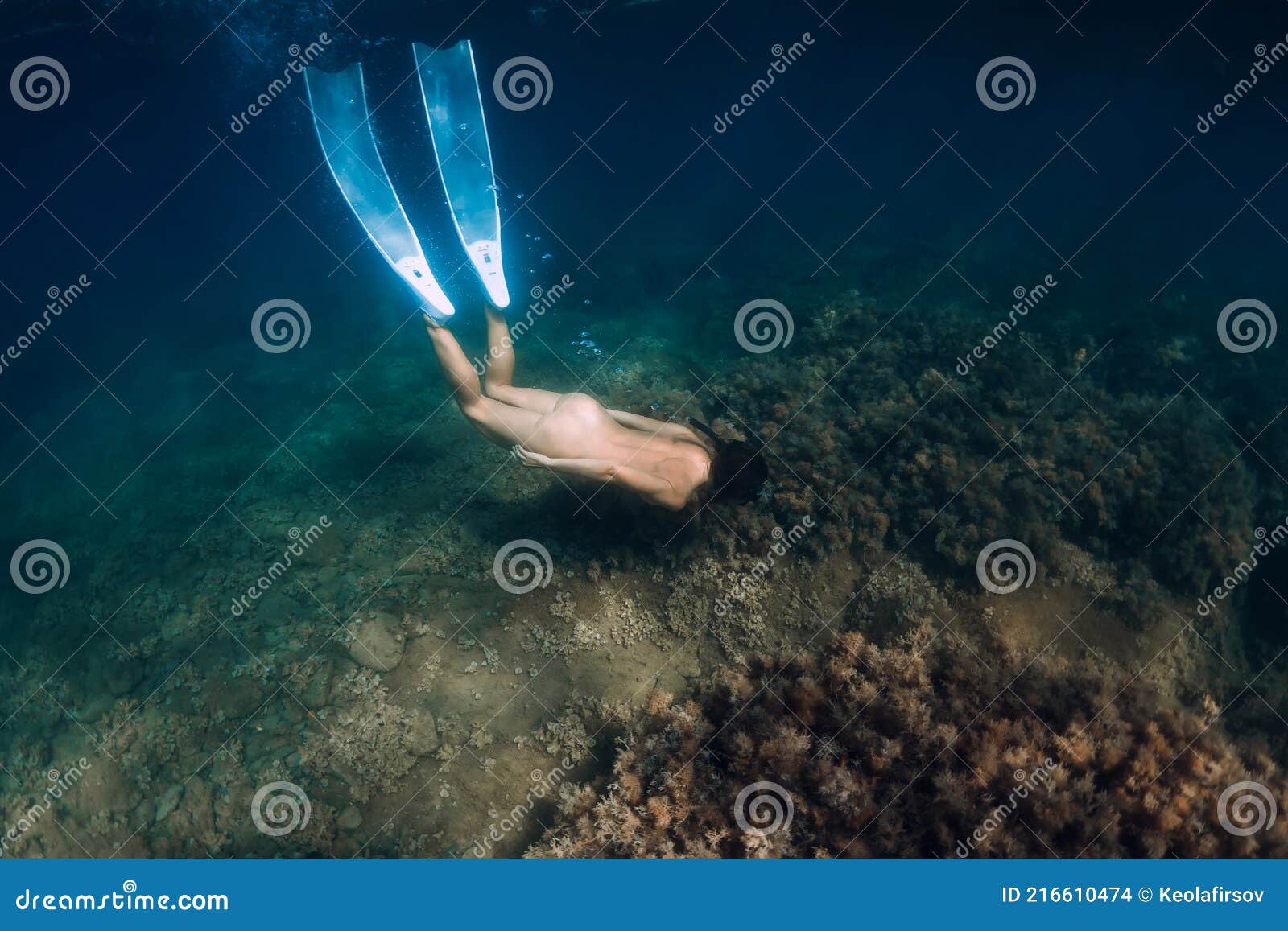 Naked Sporty Woman With Freediving Fins Dive In Ocean Stock Photo