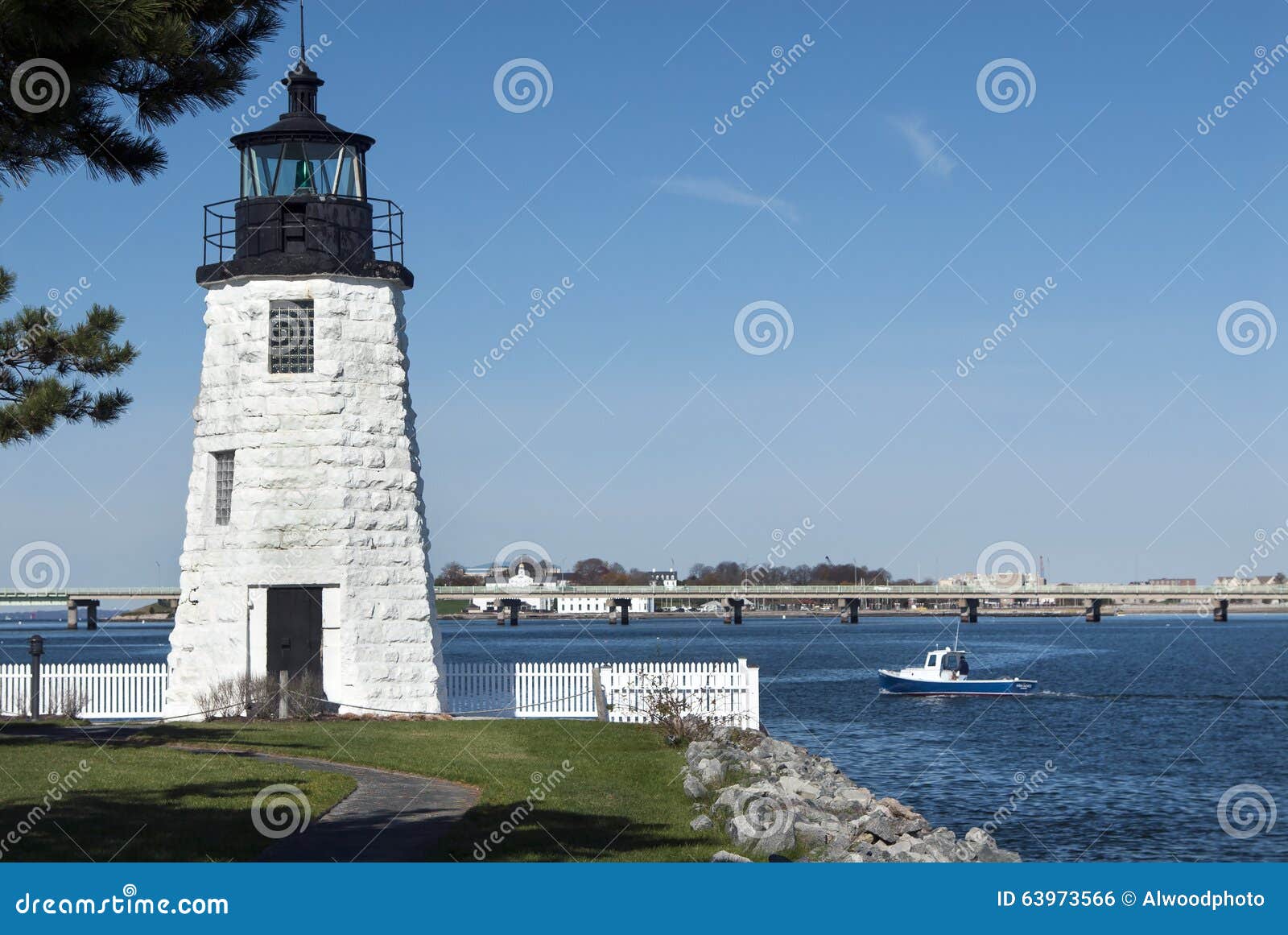 Lobster boat passes by Newport Harbor Lighthouse in Rhode Island.