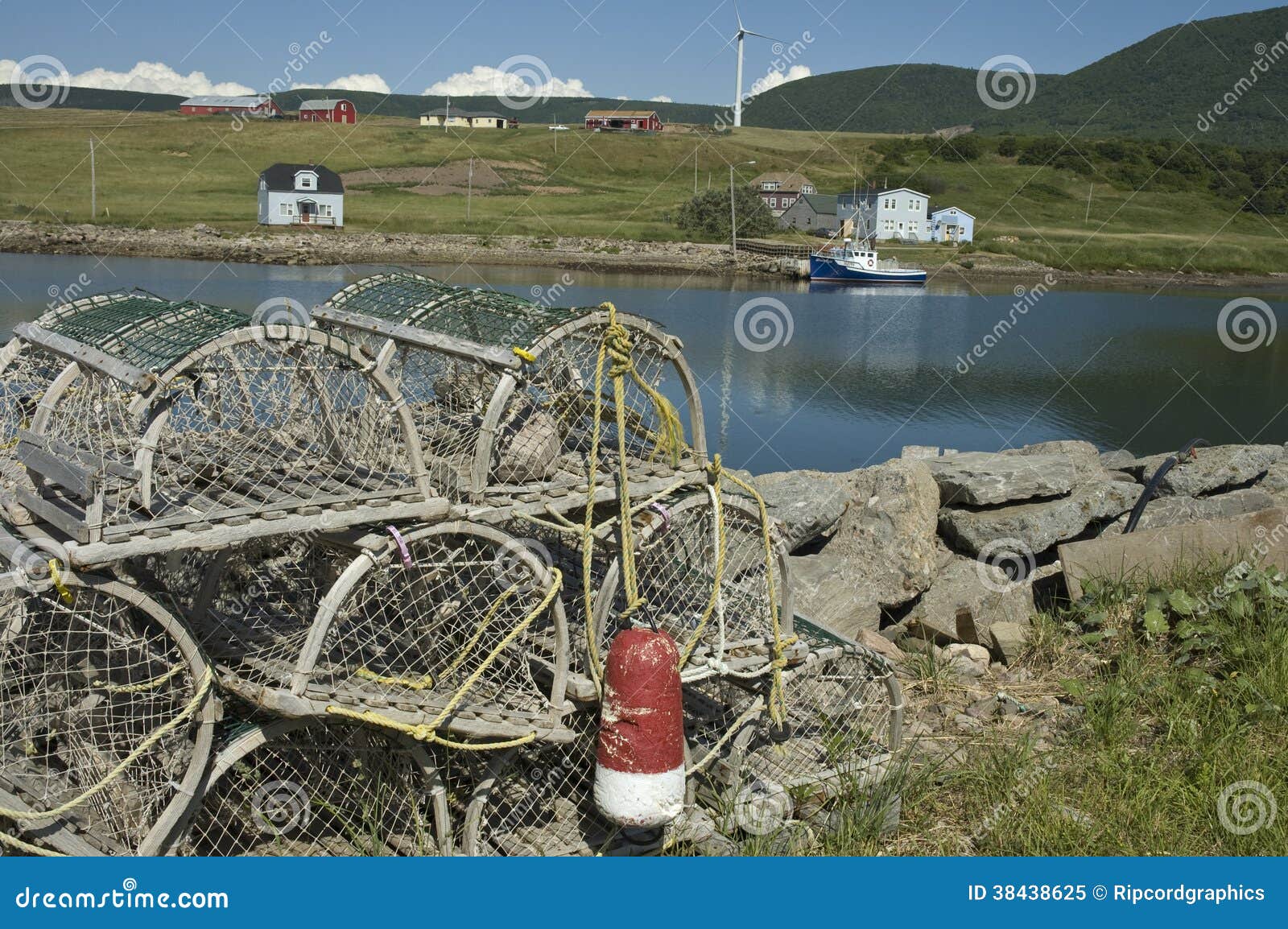 Waterfront in Nova Scotia with fishing boat and lobster traps. Wind 