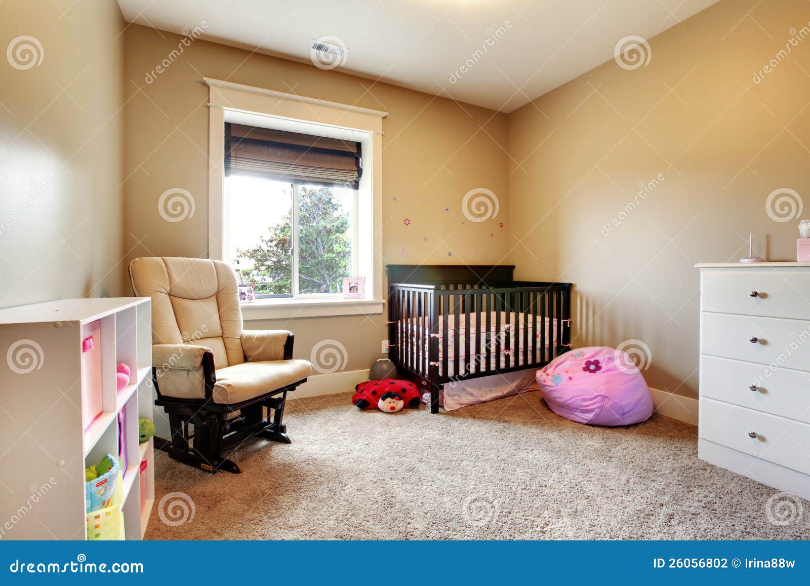 Stock Photography: Nursing room for baby girl with brown wood crib.
