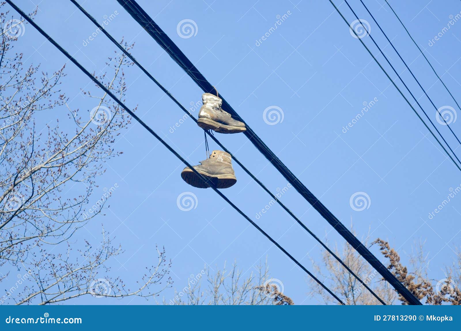 Shoes on power lines - urban scene, worn tennis shoes hanging from a