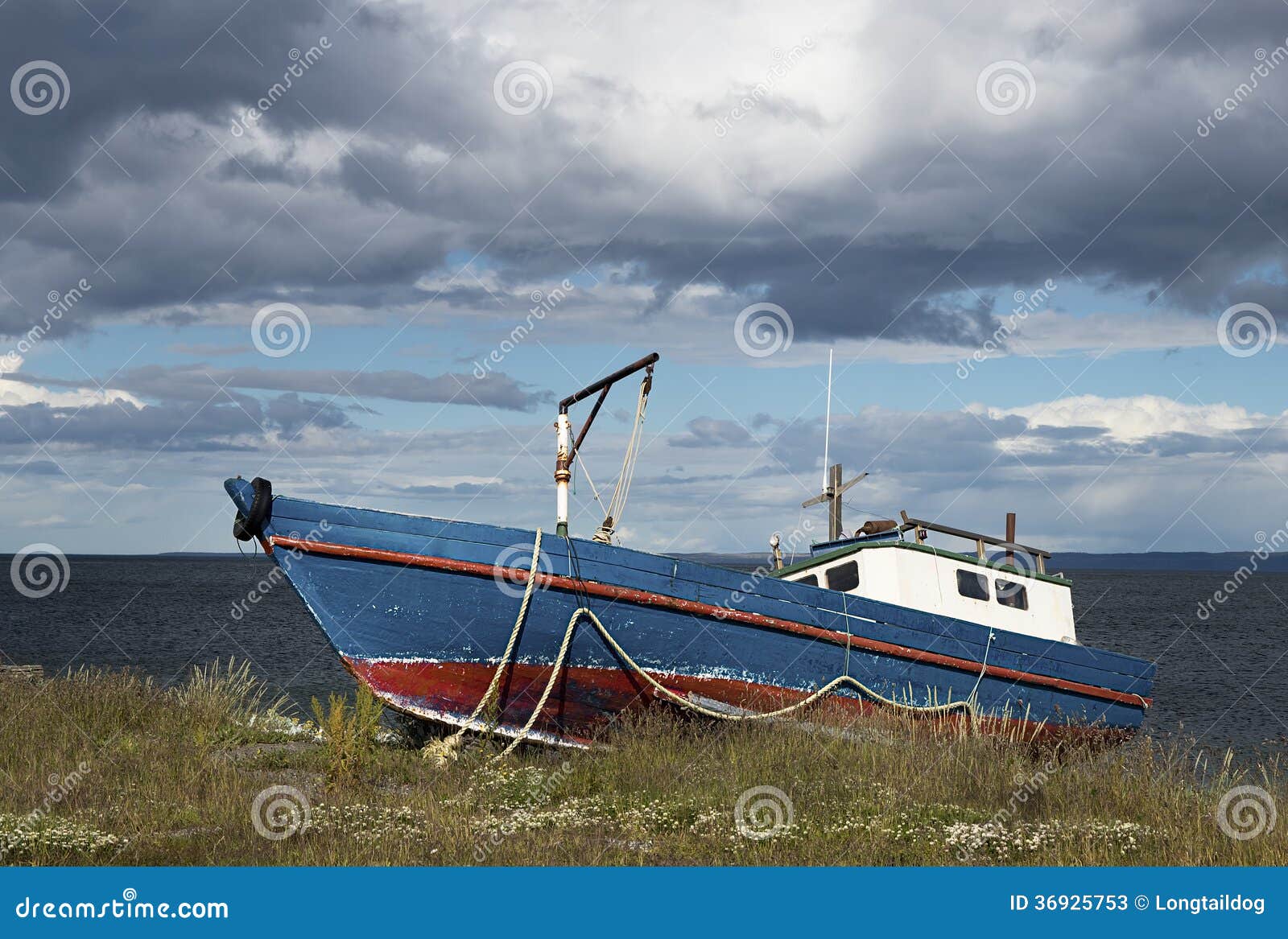 Old abandoned fishing boat on the coastline of Strait of Magellan.