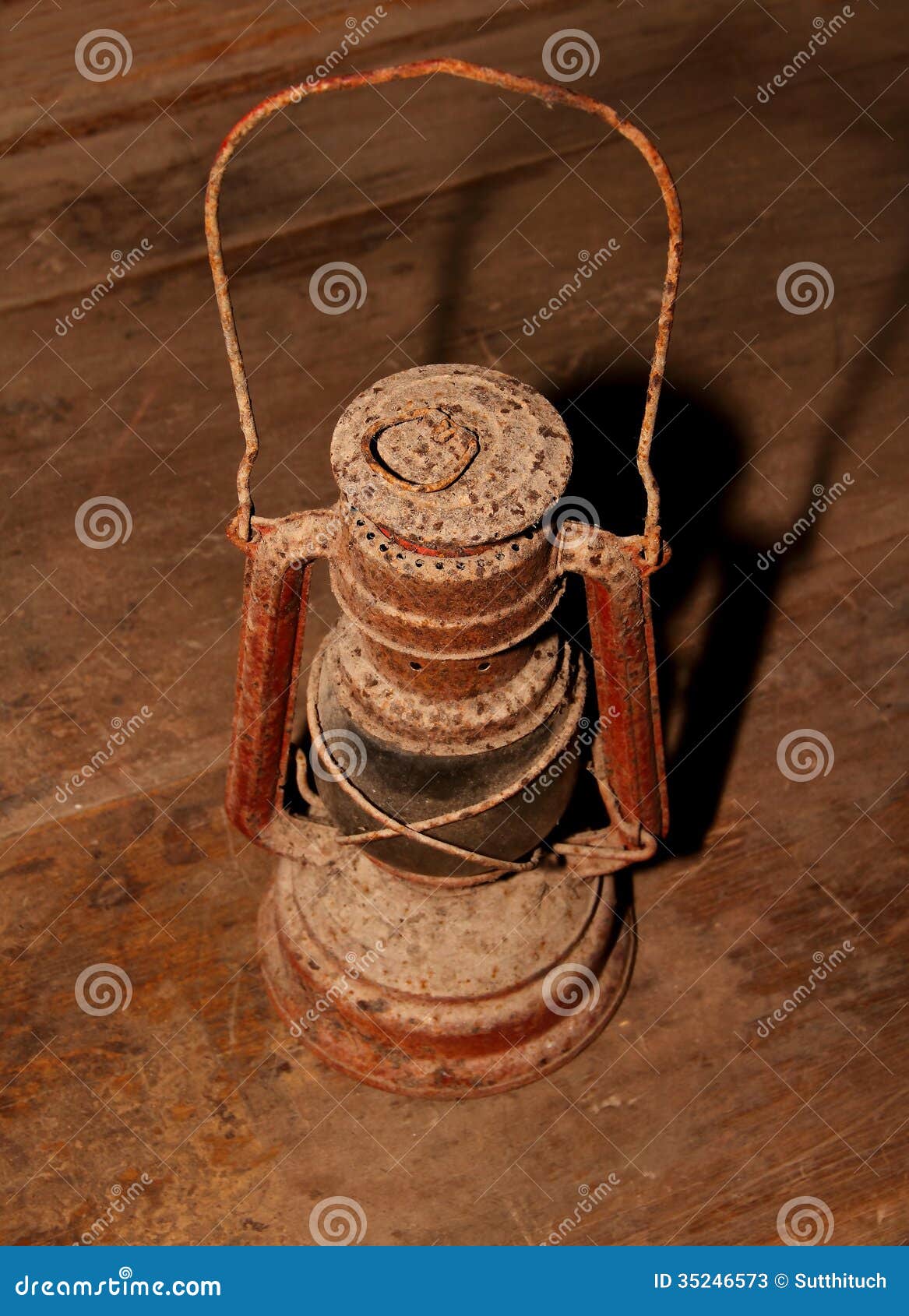Old oil lamp Isolated on wood background.