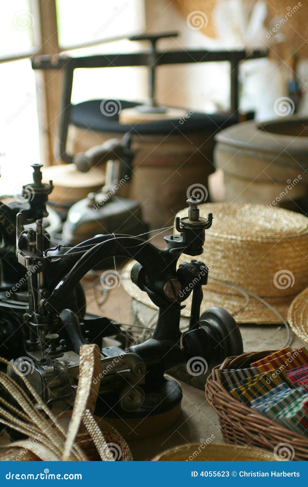 Old-fashioned hat-making shop with old-time sewing machine.