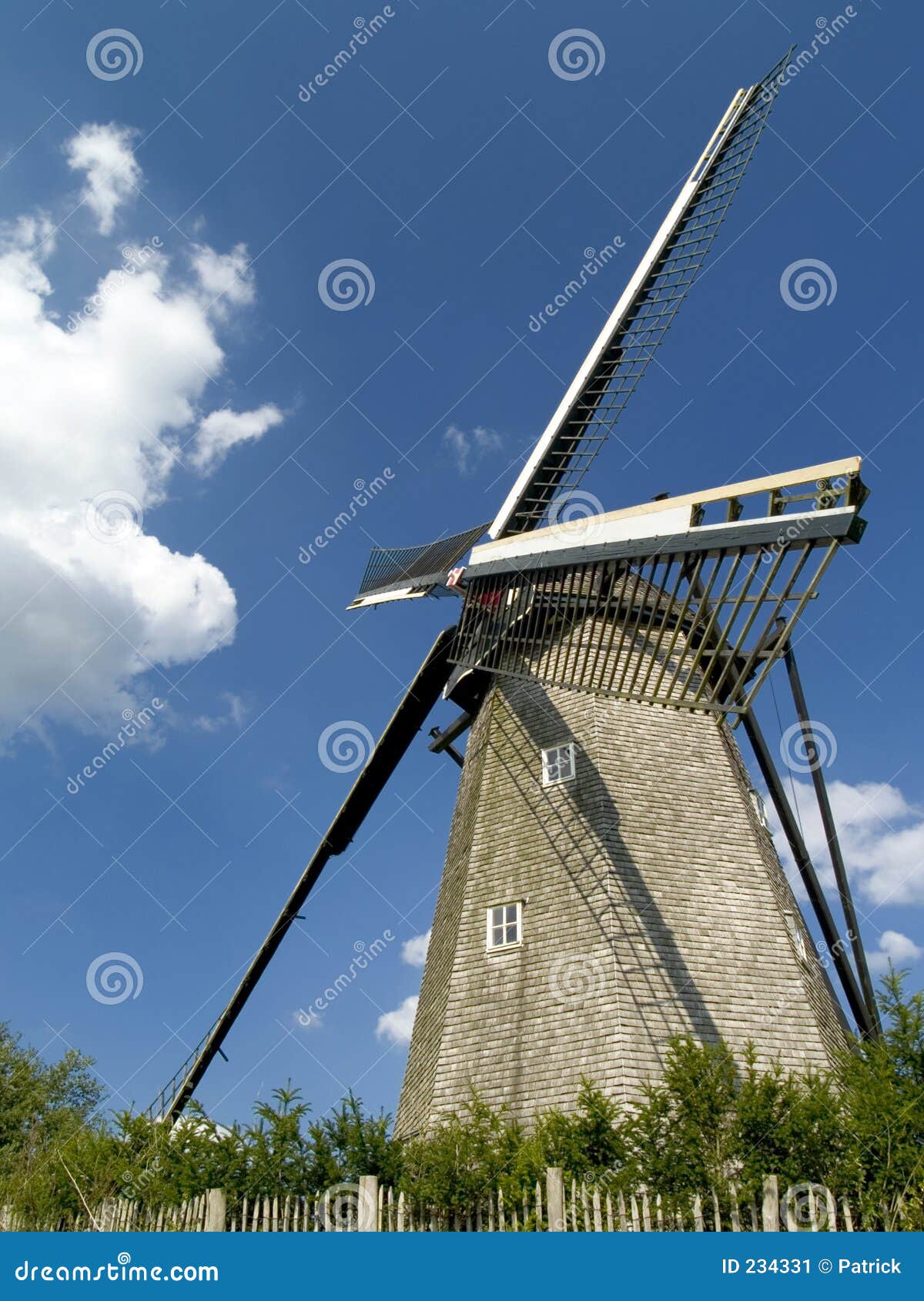 Old windmill against a blue cloudy sky on a sunny day in belgium 