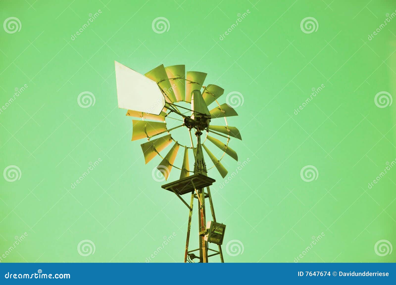 Old windmill on green background.