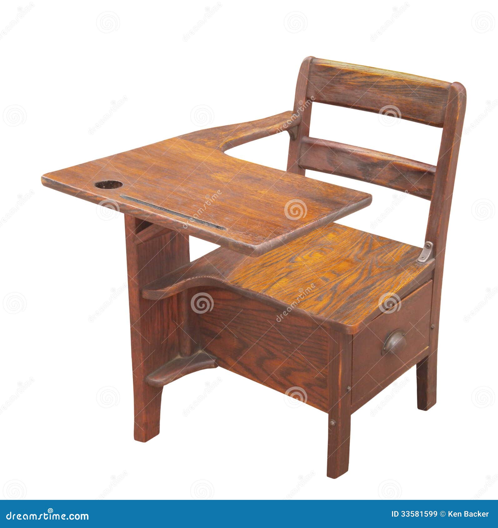 Old wooden child’s school desk with drawer. Isolated on white.