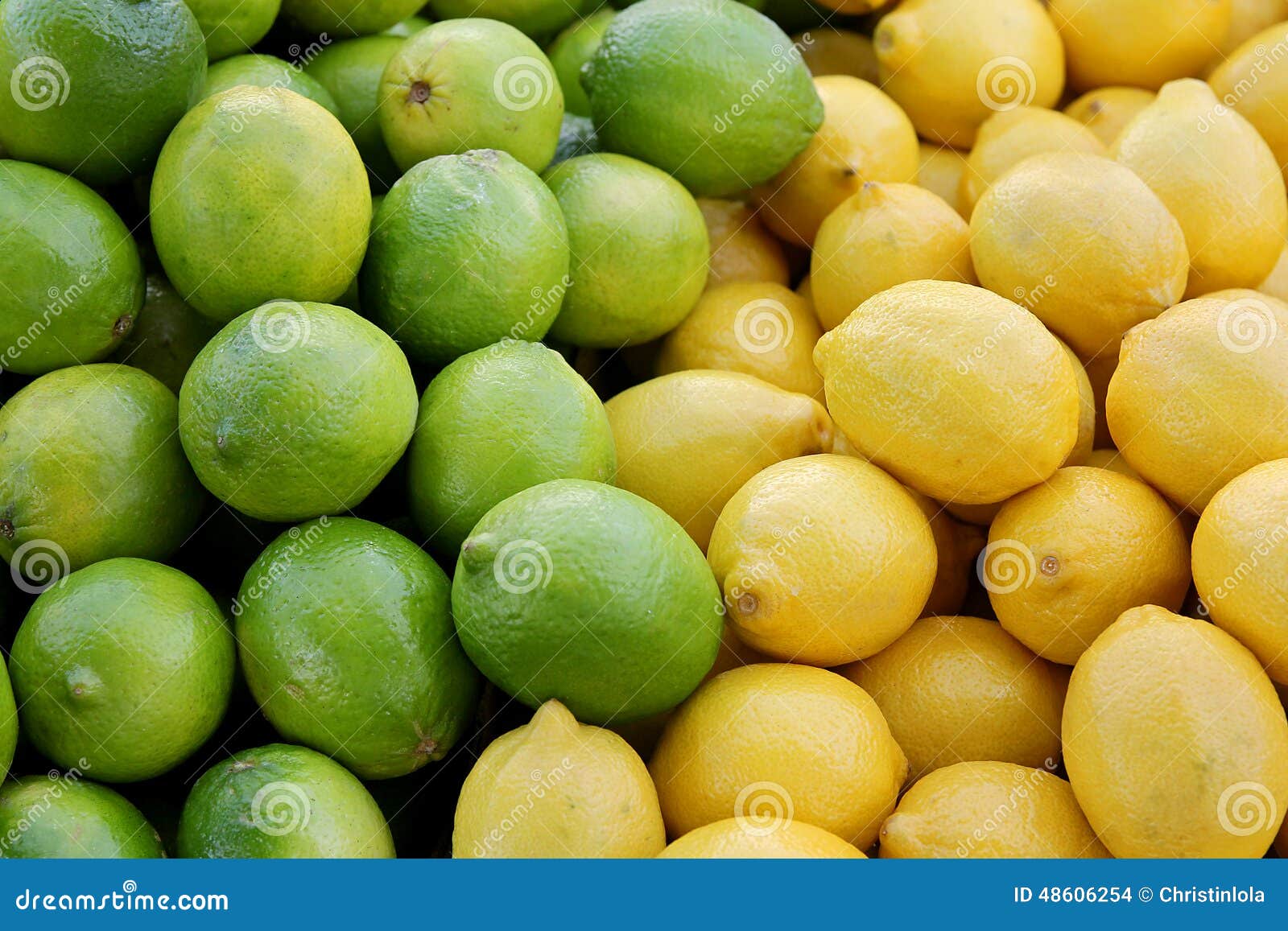 Pile Of Fresh Yellow Lemons And Green Limes At Farmer's Market Stock