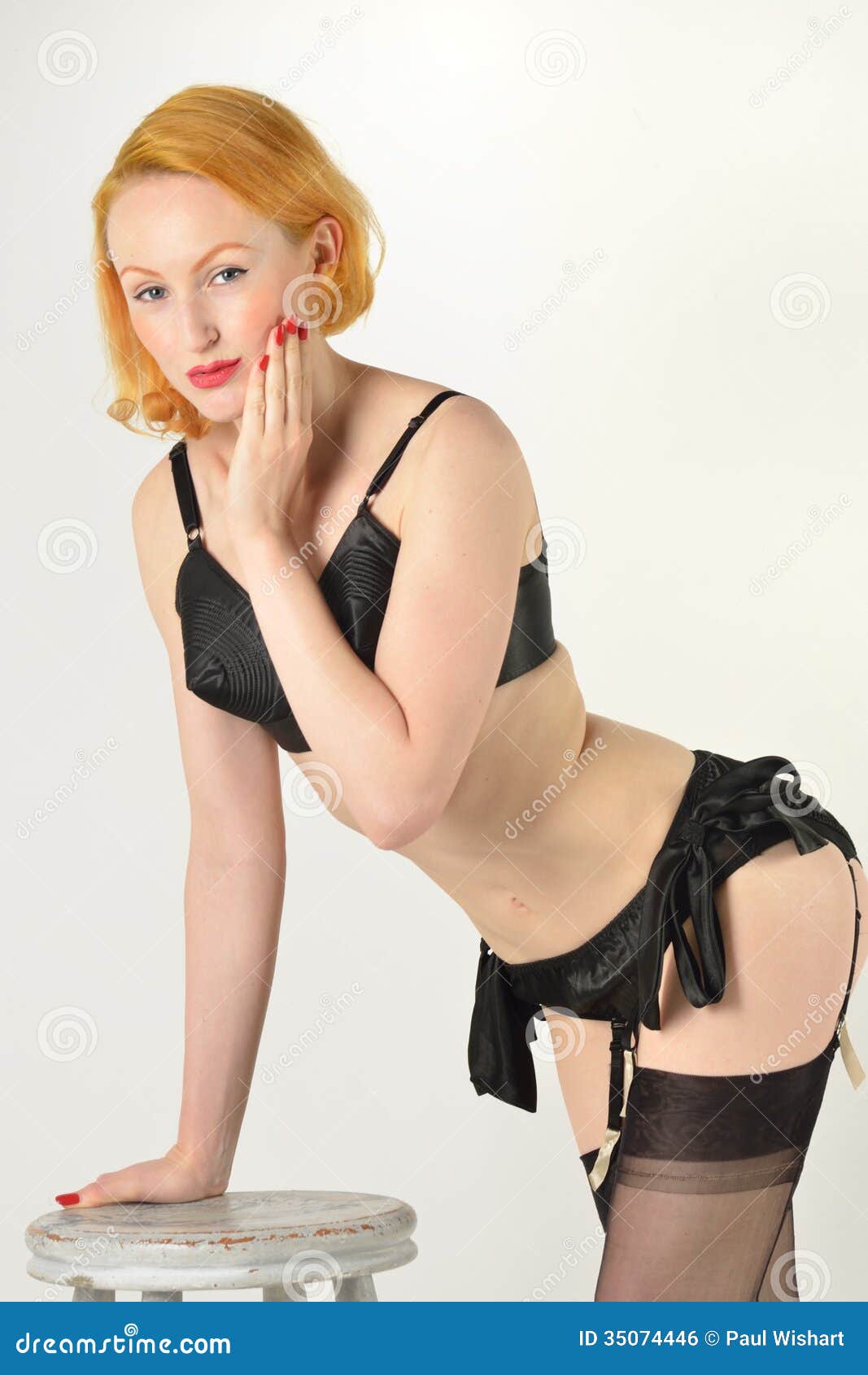 Pin Up Girl Leaning On Stool Royalty Free Stock Image