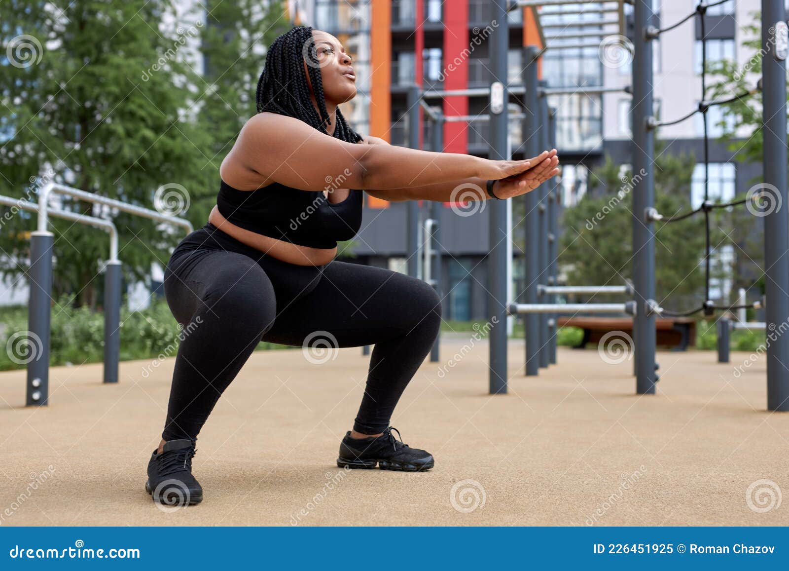 Plus Size Fat Afro American Woman Squats In Sports Ground Weight