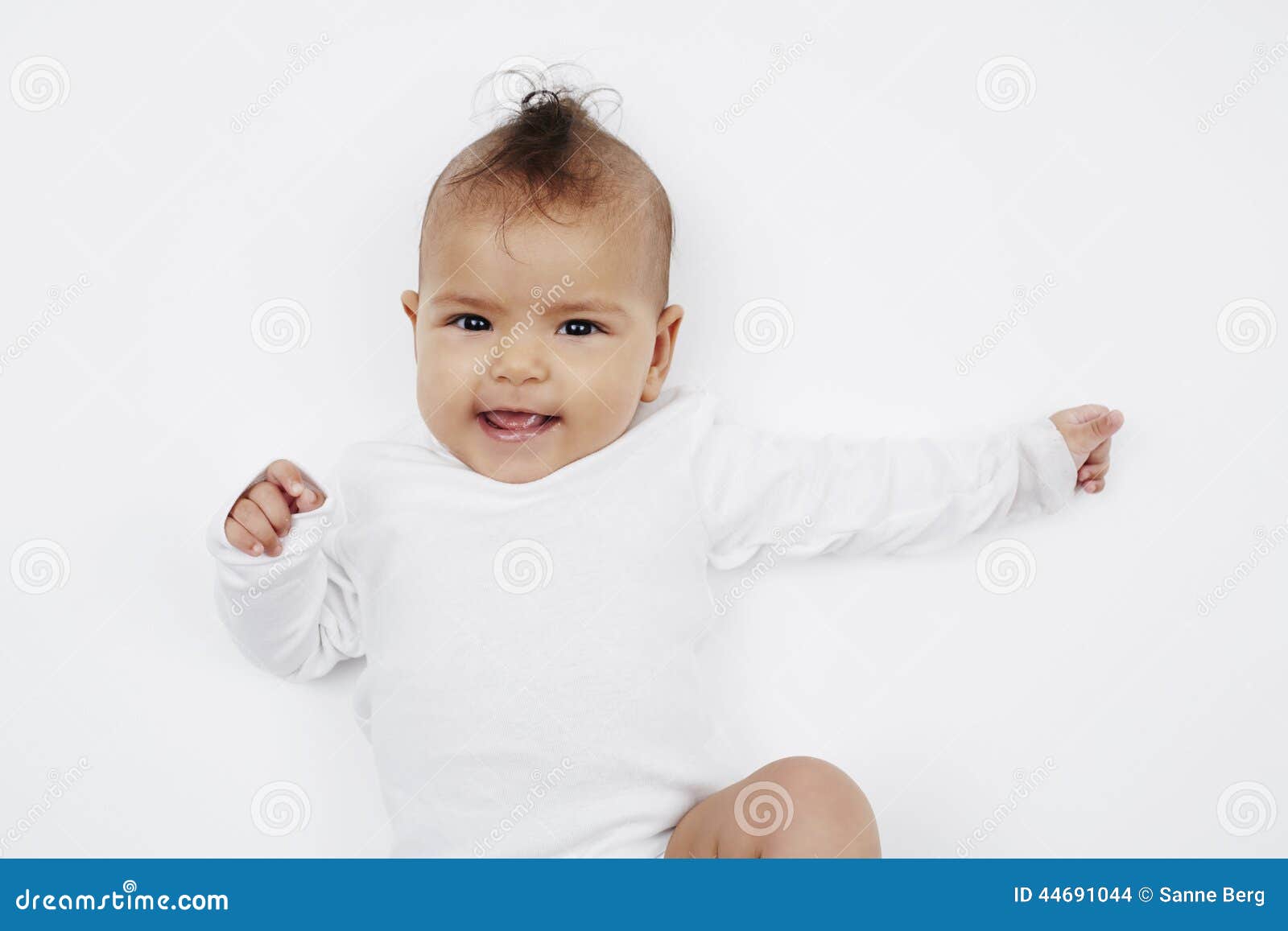 Cheeky baby girl with mohican hairstyle in baby gro.