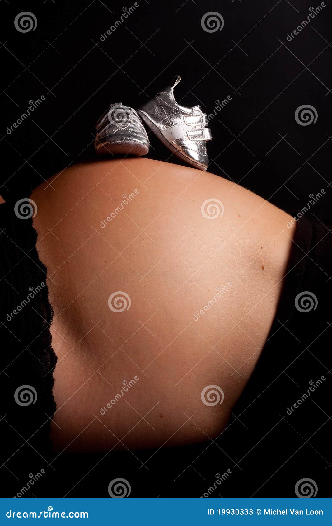 Stock Photos: Pregnant belly with silver shoes
