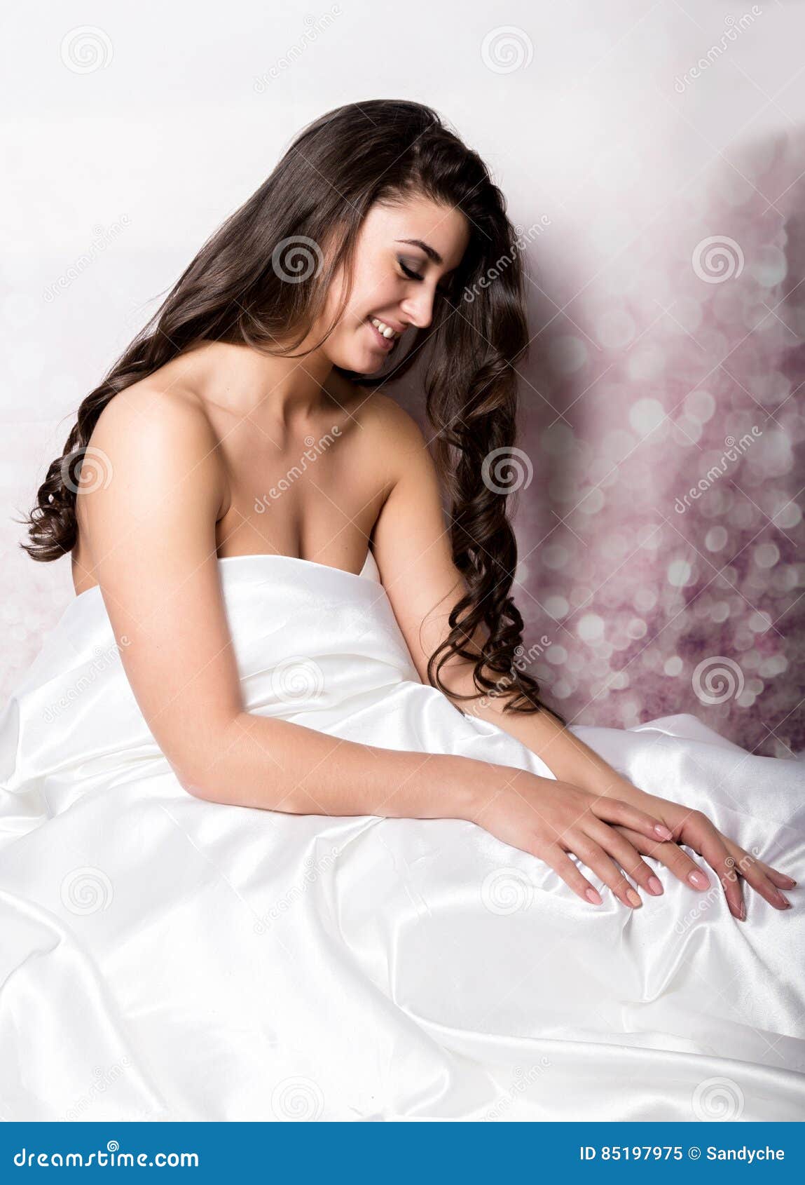 Pretty Female In Peignoir Sleeping On Bed Under Silk Sheets Stock Image
