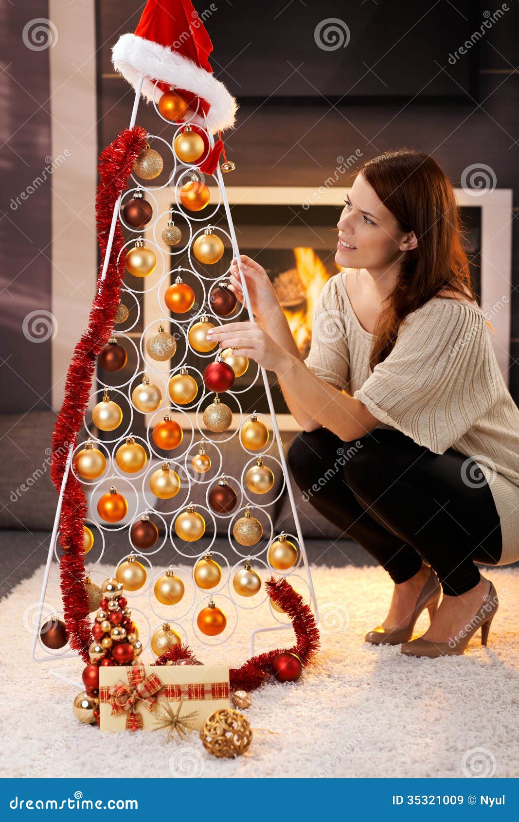 Pretty Woman Decorating Modern Christmas Tree Royalty Free Stock 