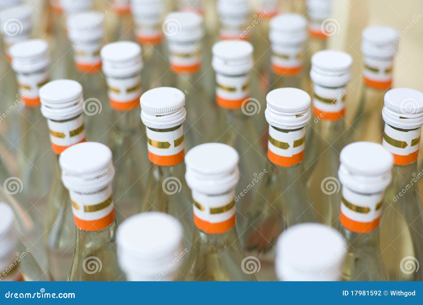 Many bottles of vodka at production line of distillery Many bottles of vodka at production line of distillery