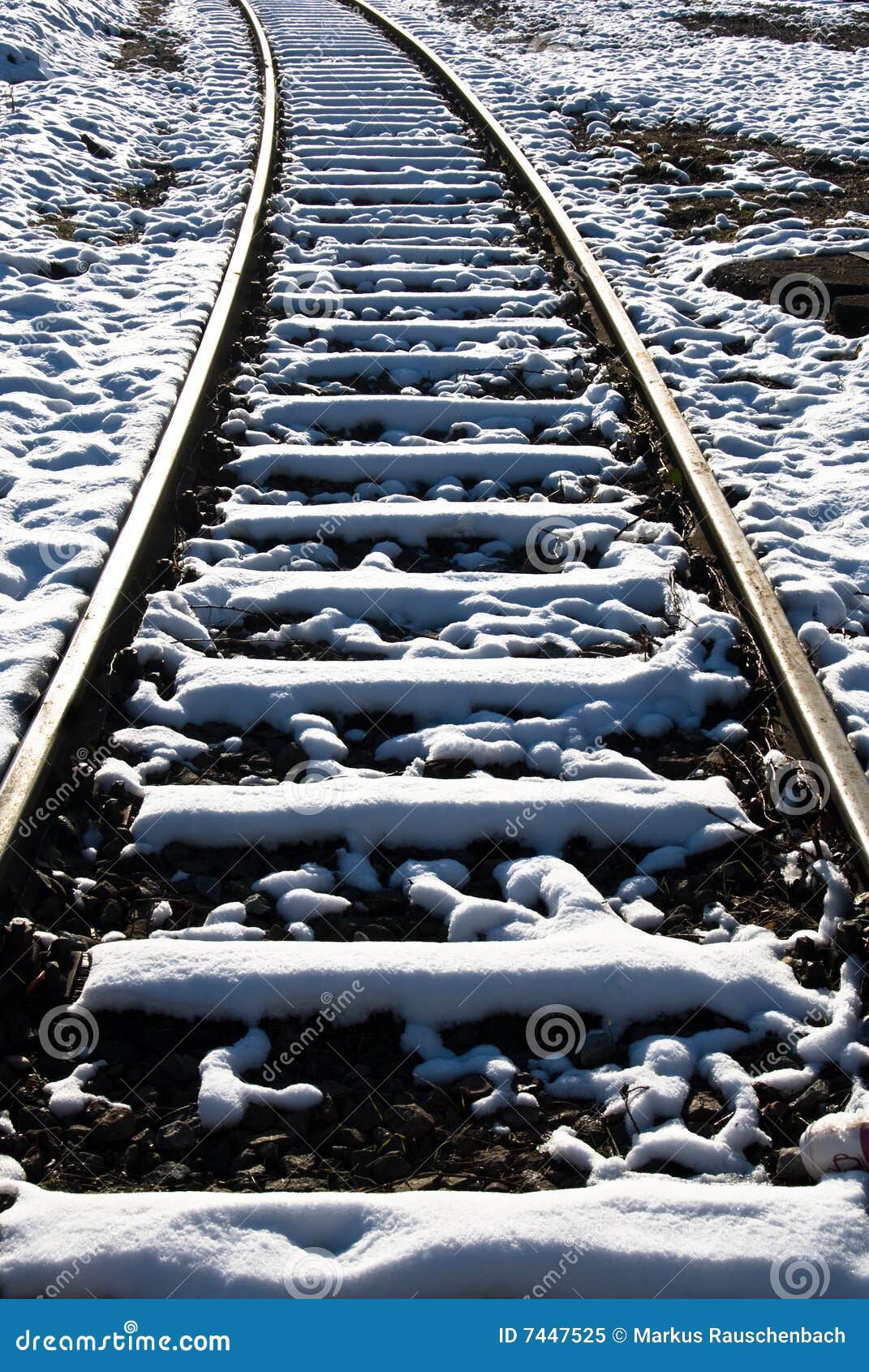 Snow on Railway tracks cross ties.