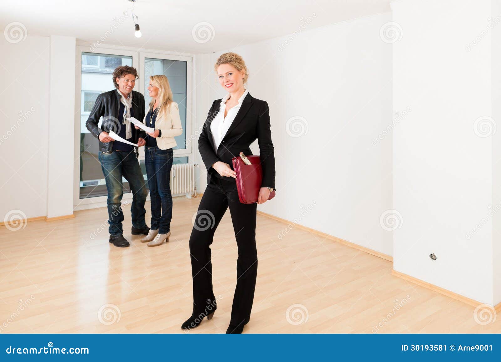 Young Couple Looking For Real Estate With Female Realtor Stock Image 