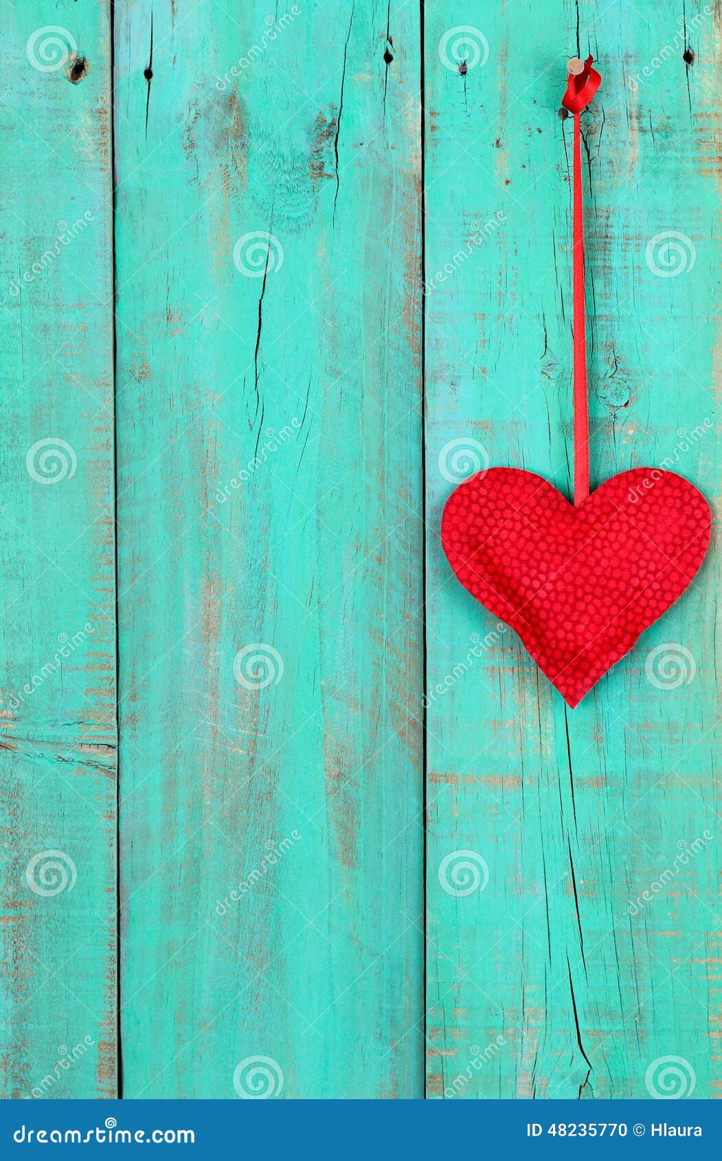 Red Heart Hanging By Ribbon On Antique Teal Blue Wooden Background 