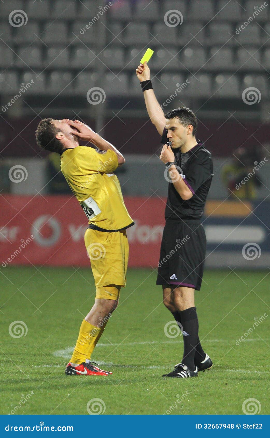 referee-shows-yellow-card-football-ovidi