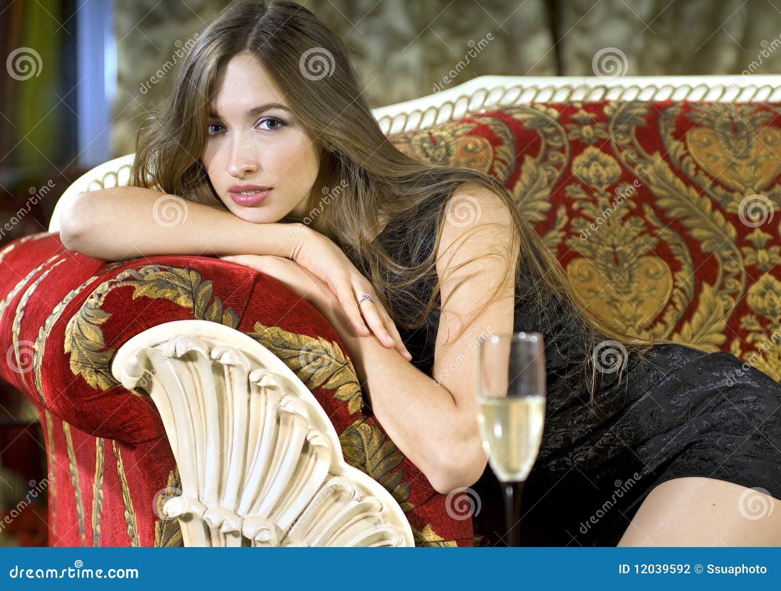 Rich Woman On A Red Expensive Sofa Stock Photography - Image: 12039592