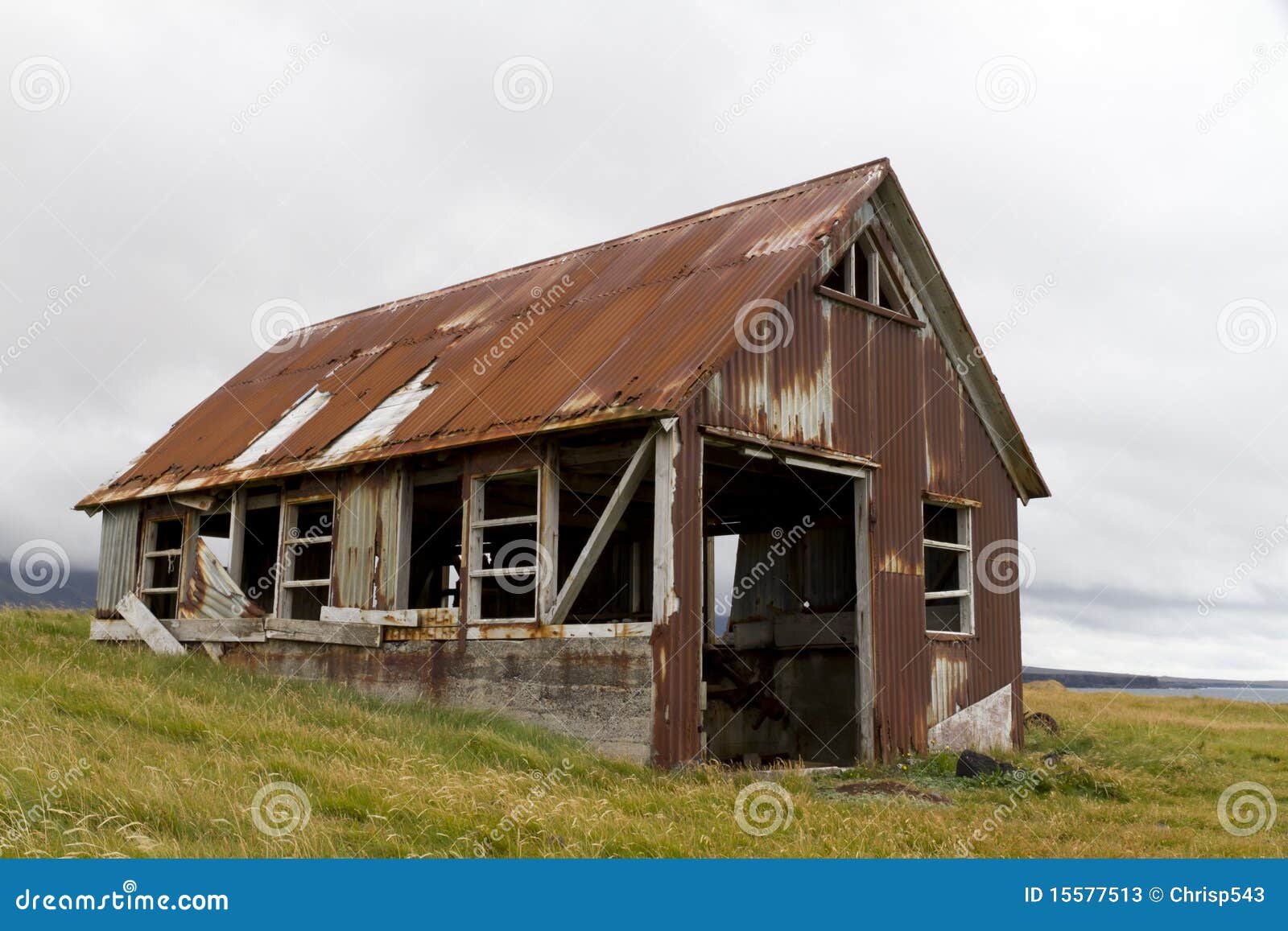 Run down old shed clad in rusty corrugated iron, situated on the coast 