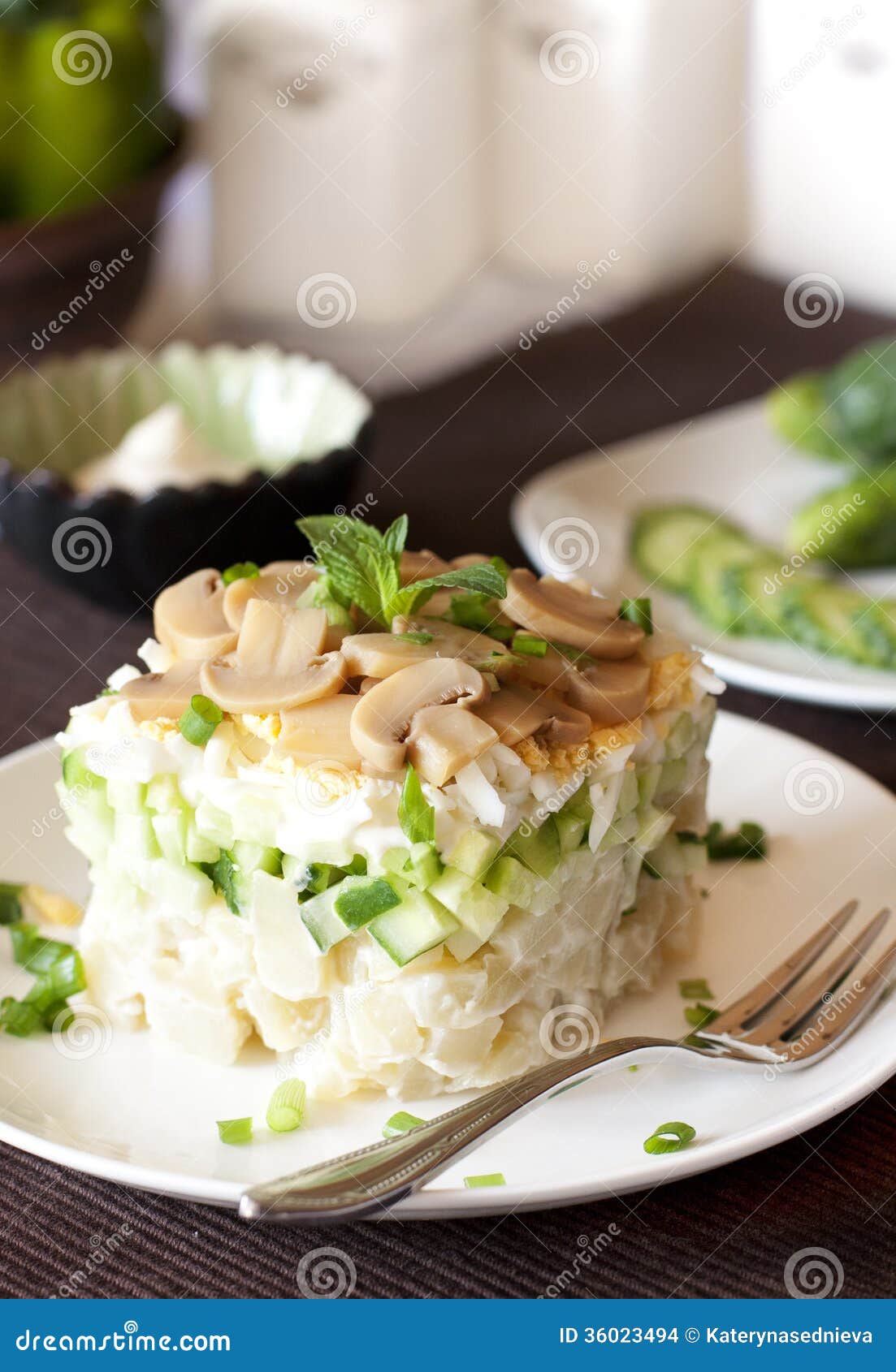 Salad with potatoes, eggs, mushrooms and pickled cucumbers, mayonnaise ...
