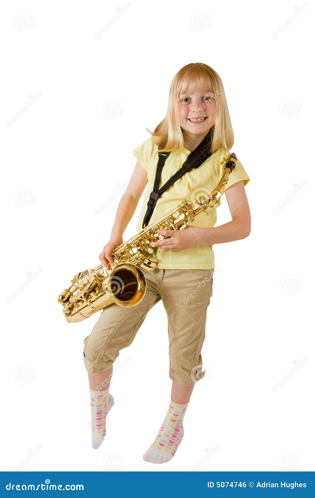 Young girl practising the saxophone against a white background.