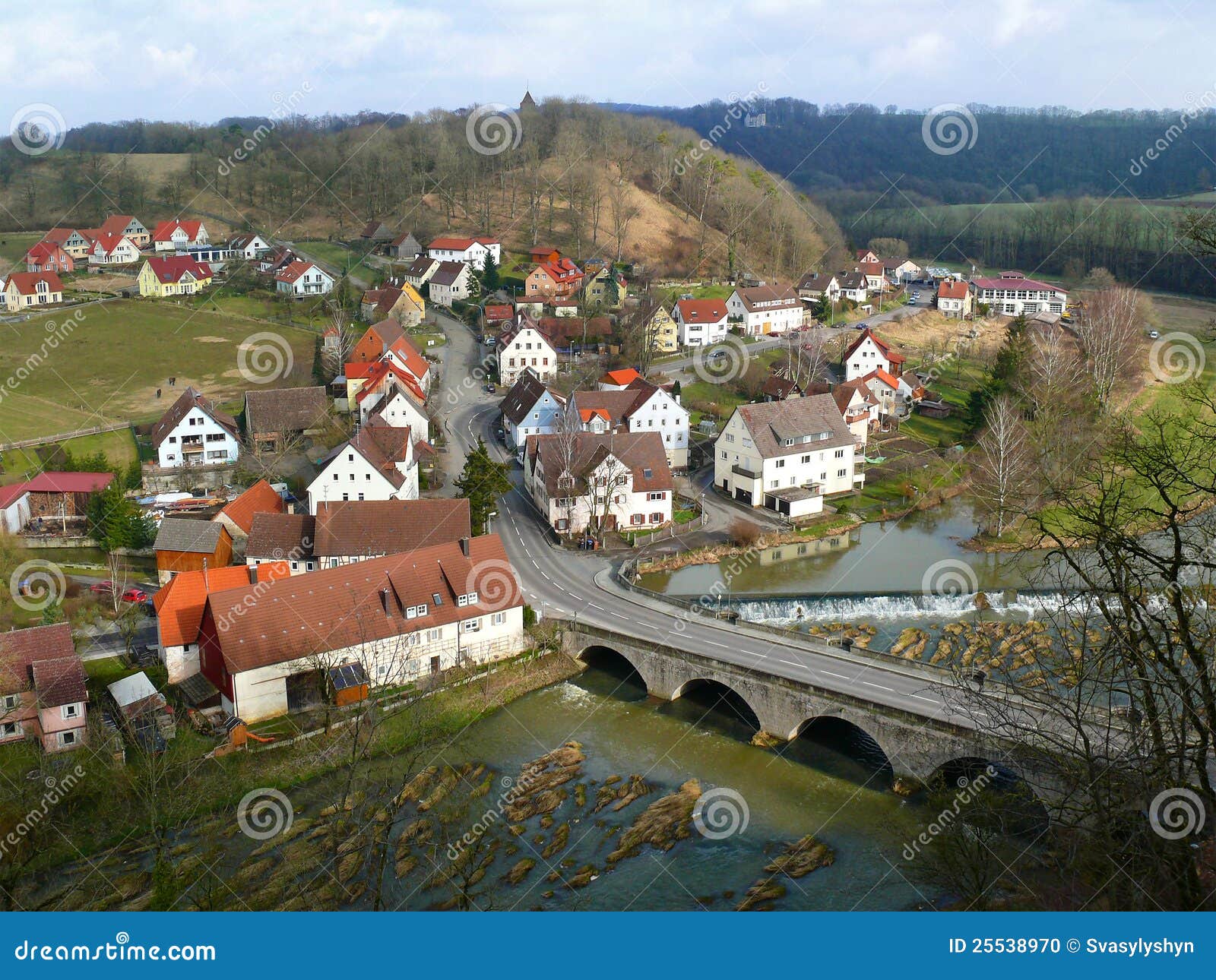 Scenery of small European town beside river and hills. Mostly all ...
