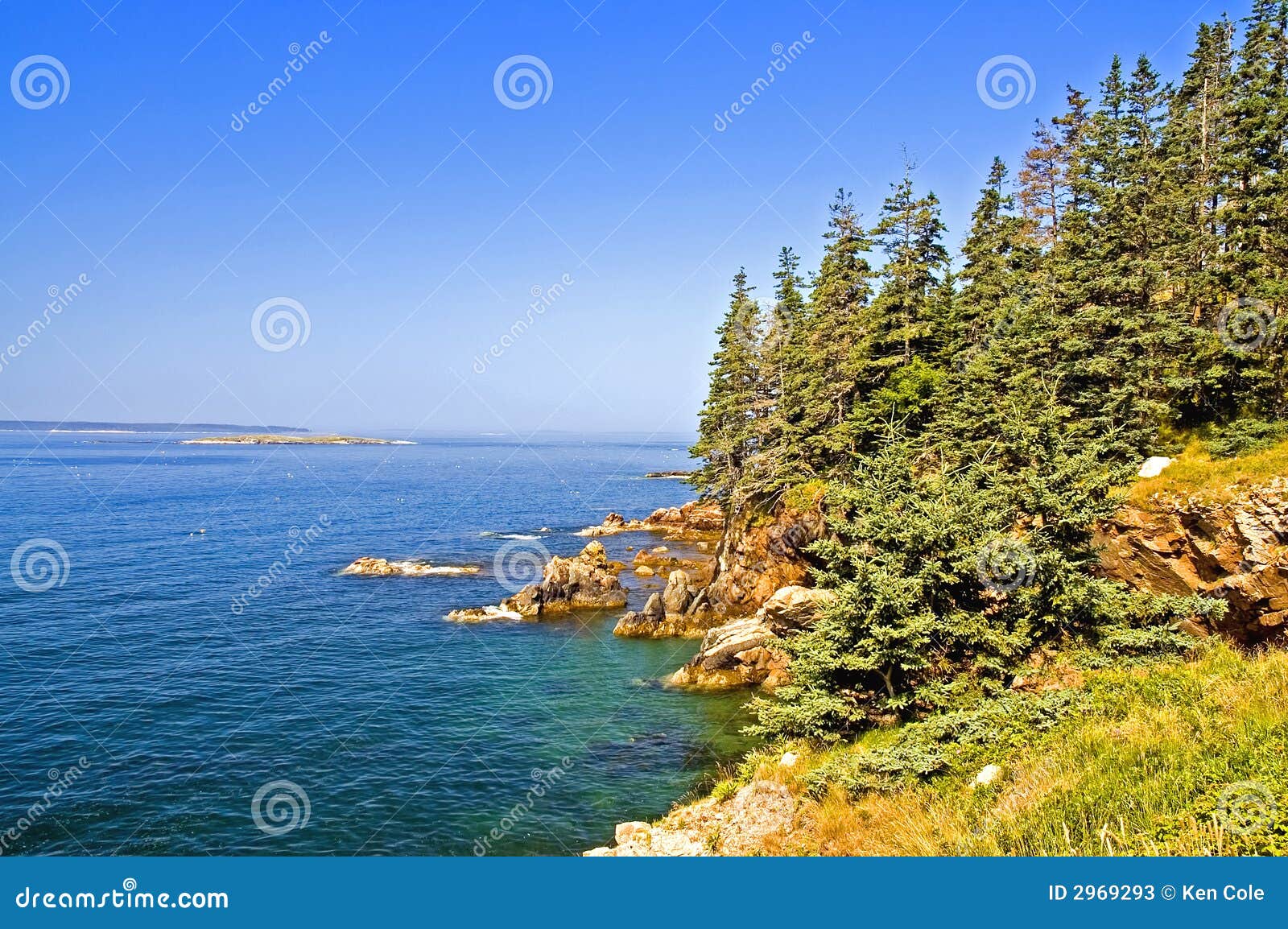 view of the beautiful rocky coastline of Maine with blue water and ...