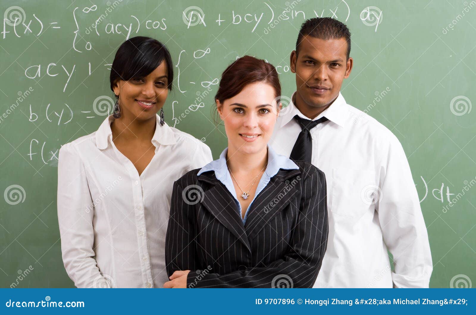 group of three teachers standing in front of a blackboard