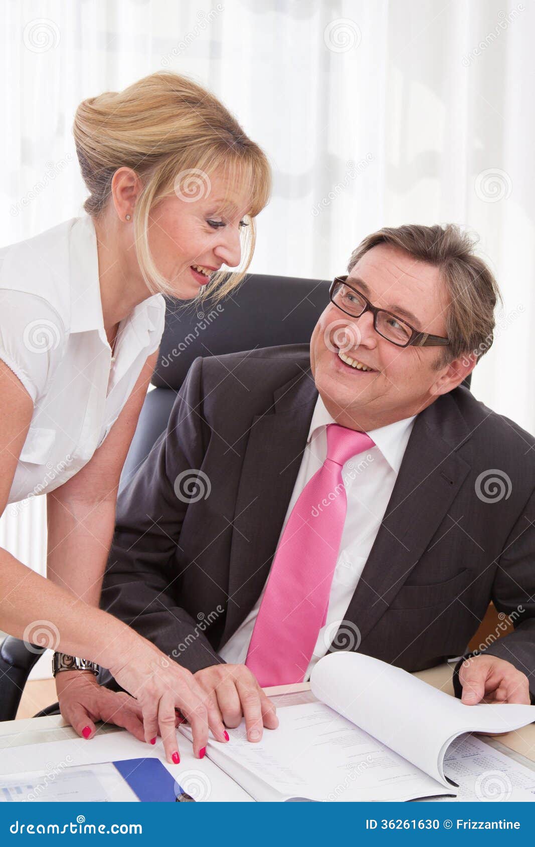 Senior Managing Director With His Secretary At Desk Stock