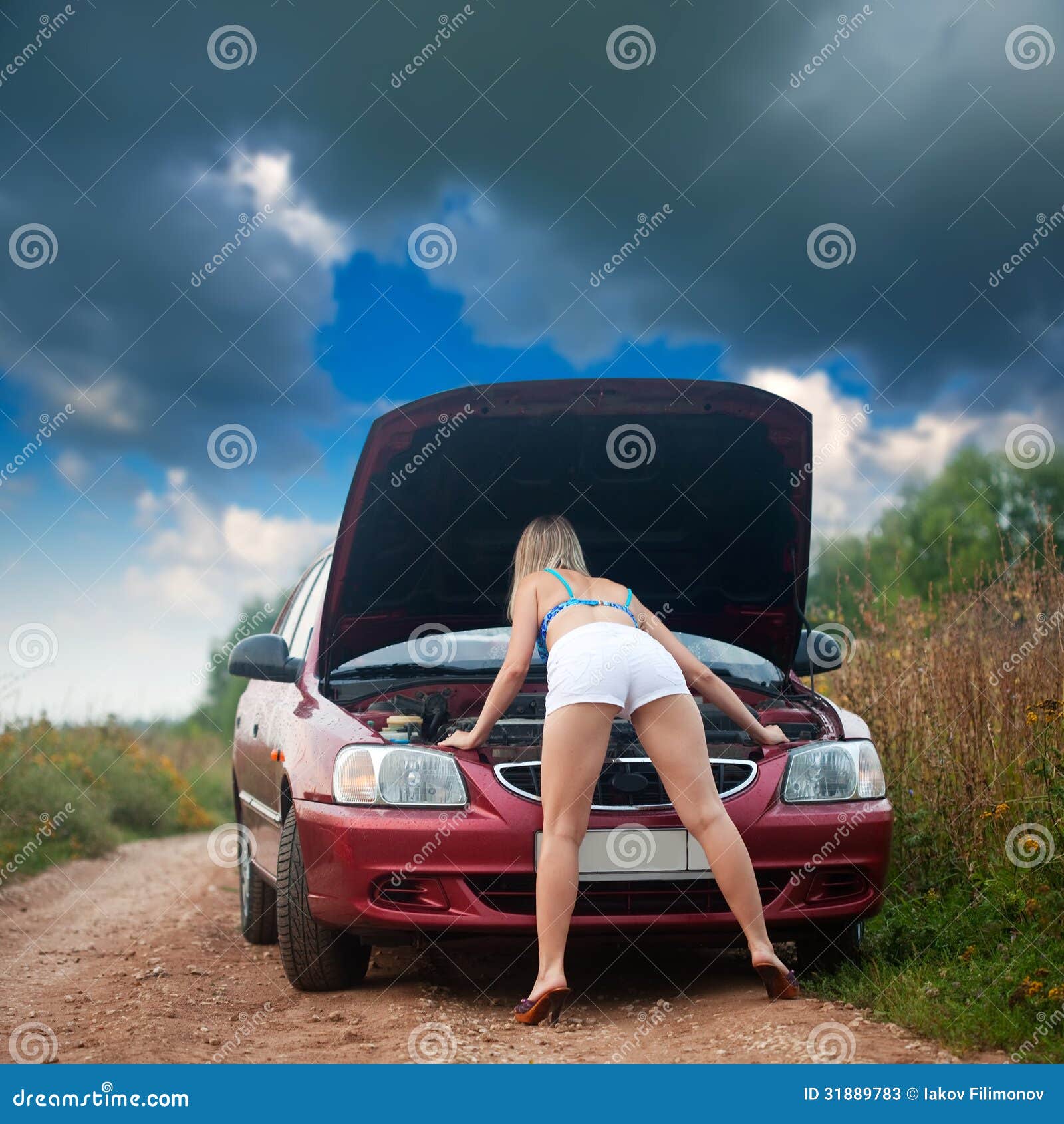 Sexy Girl Looking Under Car Hood Stock Photos