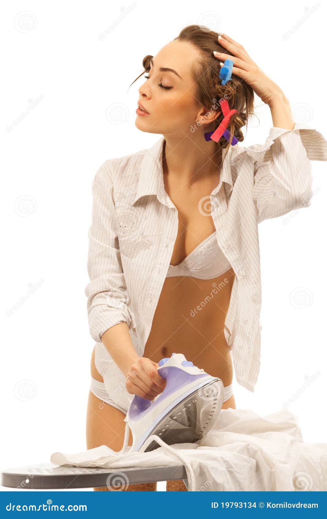 Young beautiful sexy woman ironing clothes against bright background