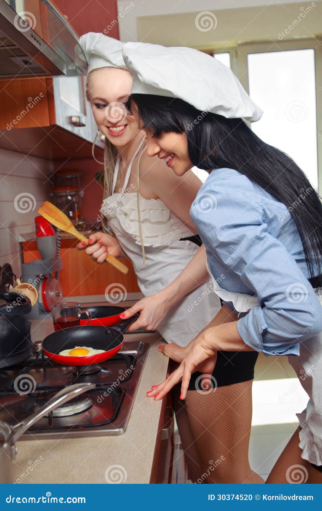 Sexy Women In Kitchen Stock